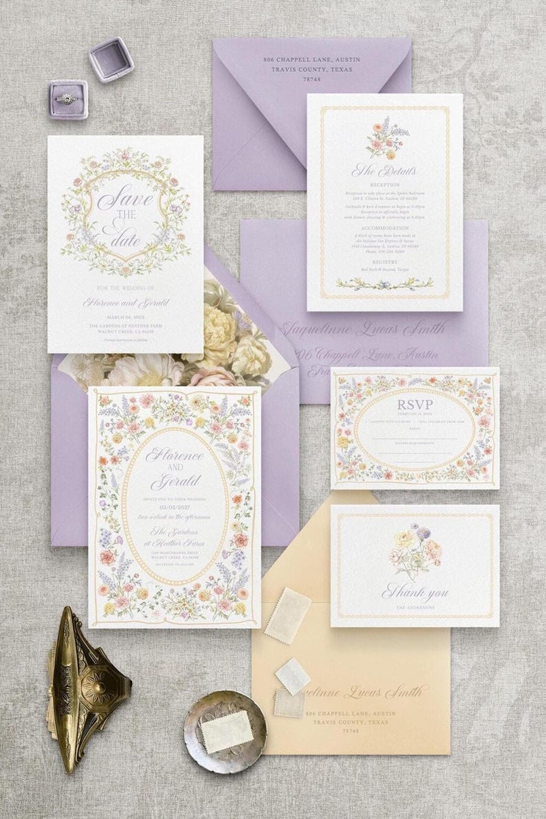 May include: A collection of wedding stationery, including invitations, RSVP cards, and thank you notes. The designs feature floral borders and elegant fonts. The color palette includes soft pastels, lavender envelopes, and a ring box.