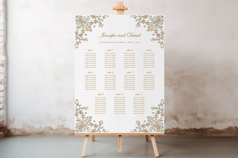 May include: A white wedding seating chart sign on a wooden easel featuring gold text that reads Jennifer and David, San Francisco, California, April 10, 202X, and lists tables 1 through 11 with placeholder names, framed by intricate floral corner borders.