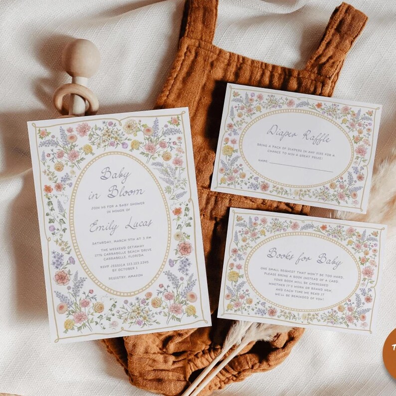 May include: A floral-themed baby shower invitation with the text "Baby in Bloom" and the name "Emily Lucas". The invitation includes details about the date, time, and location of the shower. There are also two smaller cards with floral borders, one for a diaper raffle and one for a book request.