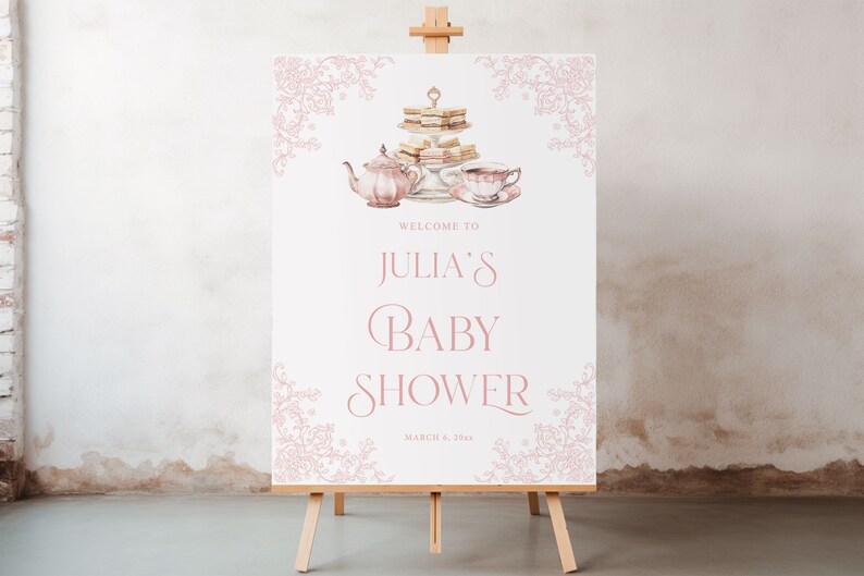 May include: A white sign with pink floral borders and a watercolor illustration of a teapot, teacups, and a tiered cake stand with sandwiches. The sign reads "Welcome to Julia's Baby Shower March 8, 2024".