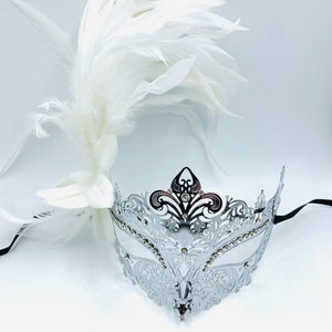 masquerade mask, masquerade mask with flower, a white gem and  white feathers, laser cut metal mask silver and white crystals