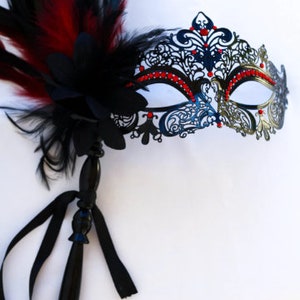 masquerade mask, masquerade mask with stick and feathers, laser cut metal mask black and red crytals