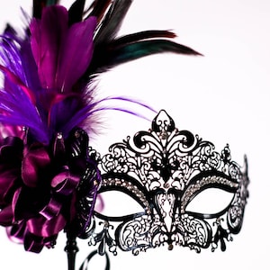 masquerade mask, masquerade mask with a stick and purple feathers, laser cut metal mask black and white crystals