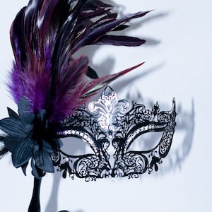 masquerade mask, masquerade mask with a stick and  purple feathers, laser cut metal mask black and white crystals