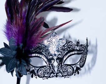 masquerade mask, masquerade mask with a stick and  purple feathers, laser cut metal mask black and white crystals