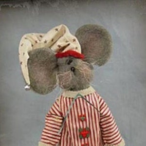May include: A gray mouse doll wearing a red and white striped pajama top and a red and white striped sleep cap. The doll is holding a red and black blanket. The doll is standing on a gray background. The image is from a doll pattern company called "Sparkles N' Sprit".