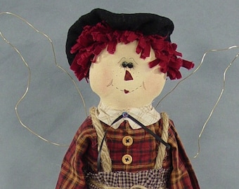 May include: A handmade rag doll with red hair, a black hat, and a plaid shirt. The doll has wire wings and is wearing red and black striped stockings and red shoes.