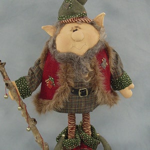 May include: A handmade Christmas elf doll with a green hat, red vest, and plaid pants. The elf is holding a stick with bells attached.