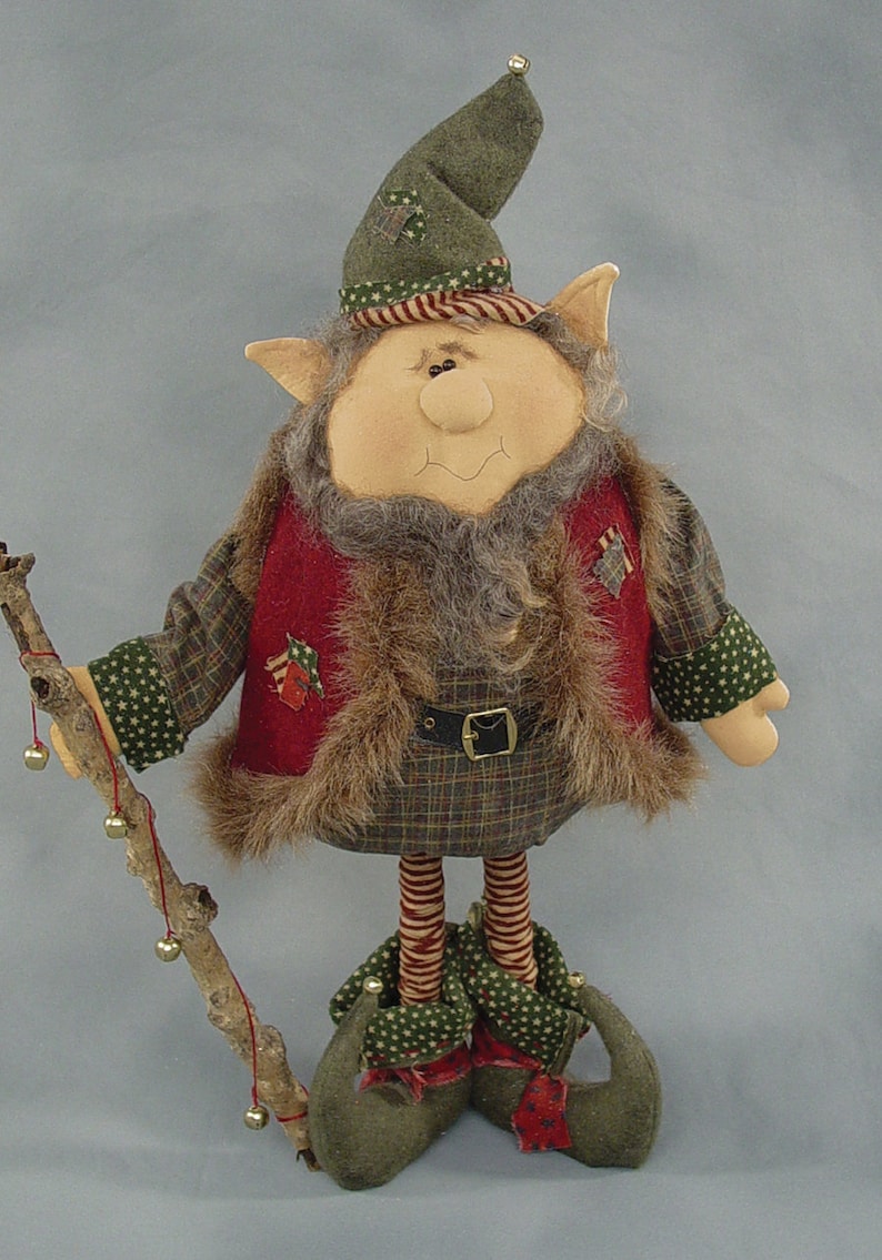 May include: A handmade Christmas elf doll with a green hat, red vest, and plaid pants. The elf is holding a stick with bells attached.