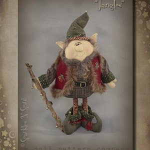 May include: A handmade elf doll named "Jangles" wearing a red and green plaid outfit with a fur trim. The elf is holding a stick with bells attached. The doll is standing on a white surface. The image is from "Sparkles N' Sprinkles" a doll pattern company.