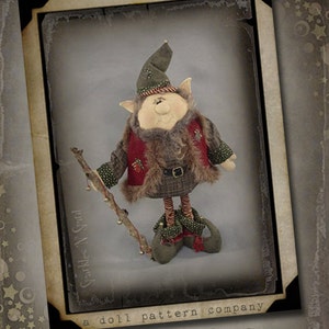 May include: A whimsical Christmas elf doll pattern with a green hat, red vest, and brown fur trim. The elf is holding a stick with bells and is standing on a brown background. The pattern is from Sparkles N' Spirit, a doll pattern company.