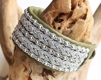 Sami leather cuffs, with five braids of spun pewter threads and sterling silver beads.