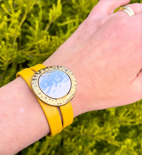 Wrap around reindeer leather bracelet with a magnetic clasp. Made with hammered gold ring and silver round sliders.