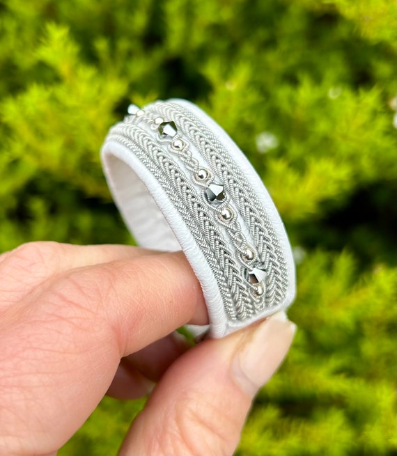 Nordic Sami inspired reindeer leather cuff bracelet, with traditional pewter braiding, chrystals and sterling silver beads.