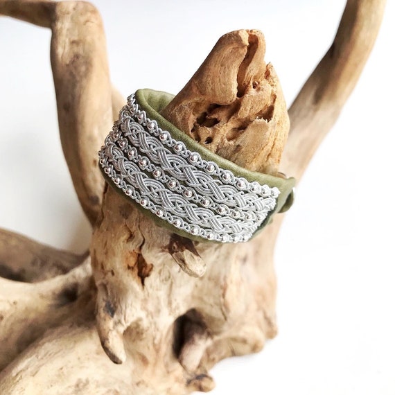 Sami leather cuffs, with five braids of spun pewter threads and sterling silver beads.