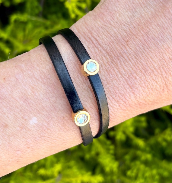Double wrap around thin leather bracelet, with two small crystals in golden setting . Made with a golden magnetic clasp.