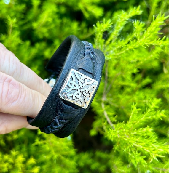 Unisex leather cuff with Trinity Celtic feature and leather braids.