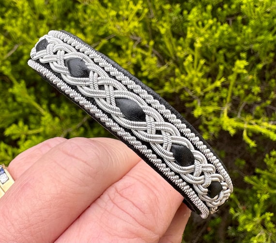 Nordic traditional Sami leather bracelet with borders of silver and pewter braiding. Unisex wristband accessory made to order.