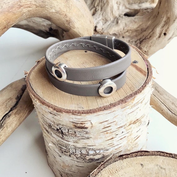 Wrap around reindeer leather bracelet with a magnetic clasp and two circular silver sliders.