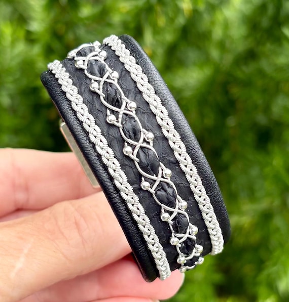 Sami inspired cuffs with reindeer and salmon leather combination. Made with three braids of pewter and sterling silver beads.
