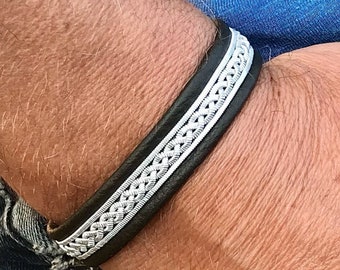 Sami leather bracelets with a braid of wider flat pewter threads and borders. Handmade unisex design.