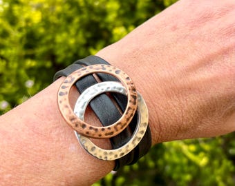 Wrap around reindeer leather bracelet with a magnetic clasp. Made with hammered copper ring and silver ring sliders.