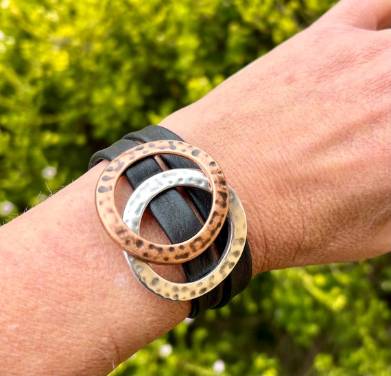 Wrap around reindeer leather bracelet with a magnetic clasp. Made with hammered copper ring and silver ring sliders.