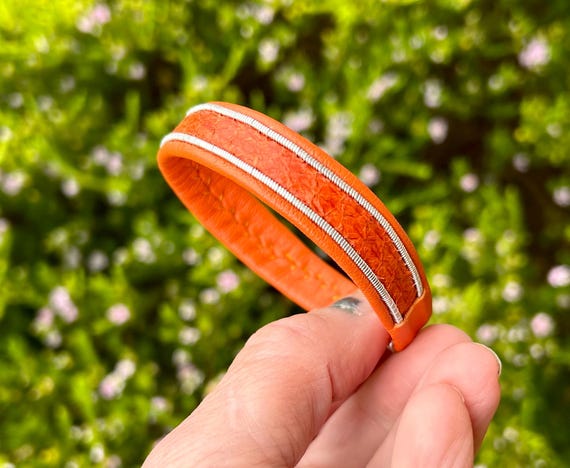 Salmon and reindeer leather 1.5cm wide bracelet, with borders of flat spun pewter and a magnetic clasp.