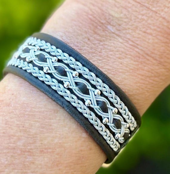 Sami reindeer leather bracelets with three rows of pewter braids and sterling silver beads. Sizes XS-XL.