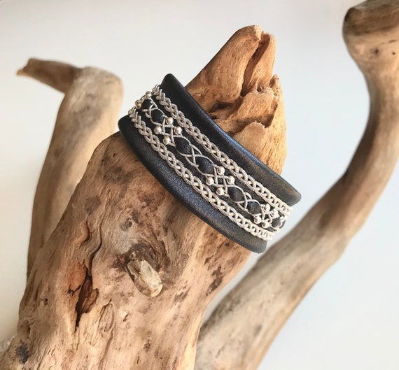 Traditional Sami leather inspired cuffs, with three braids of spun pewter and sterling silver beads. The borders of flat pewter threads.