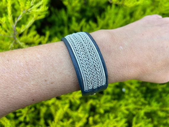 Traditional Nordic Sami inspired leather cuff, with pewter silver thread braids and a tree of life pewter button. Handmade to order