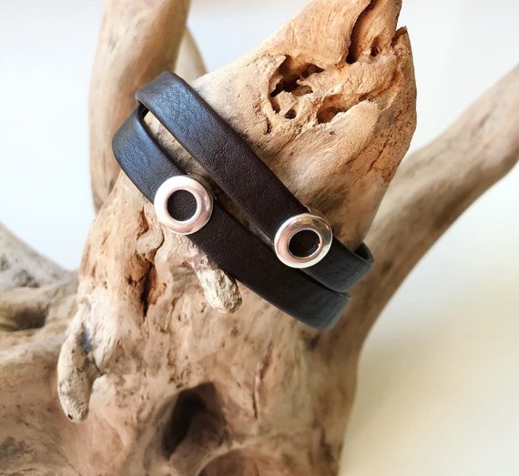 Wrap around Nordic reindeer leather bracelet with a magnetic clasp and two circular silver sliders.