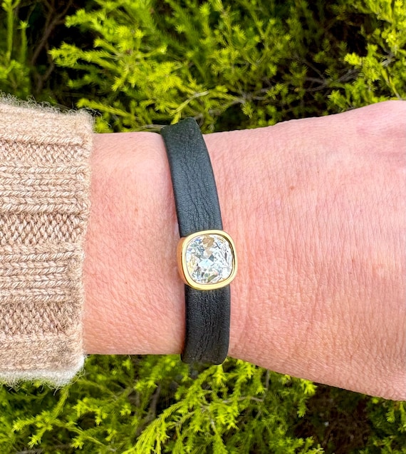 Leather bracelet using Nordic reindeer leather with magnetic clasp and a square crystal slider in gold setting.