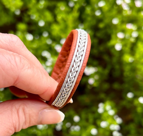 Sami leather bracelets with a braid of flat pewter threads and flat borders. Handmade unisex design.