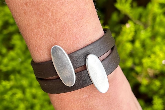 Wrap around Nordic reindeer leather bracelet with a magnetic clasp and two oval slightly hammered silver sliders.