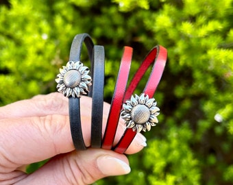 Double wrap around leather bracelet, with a small silver sunflower magnetic clasp.