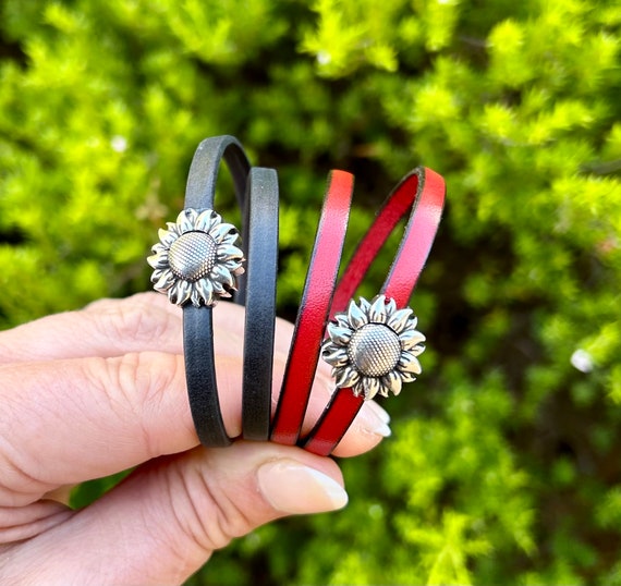 Double wrap around leather bracelet, with a small silver sunflower magnetic clasp.