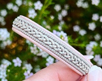 Nordic Sami reindeer leather bracelet, braided with wide flat silver and pewter threads and borders. A unisex design handmade to order.
