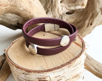 Wrap around reindeer leather bracelet with a magnetic clasp and two dimpled disc silver sliders.