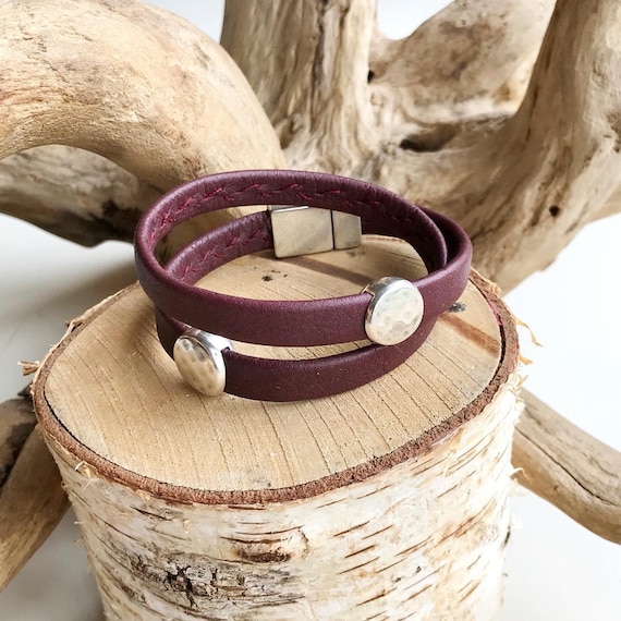 Wrap around reindeer leather bracelet with a magnetic clasp and two dimpled disc silver sliders.