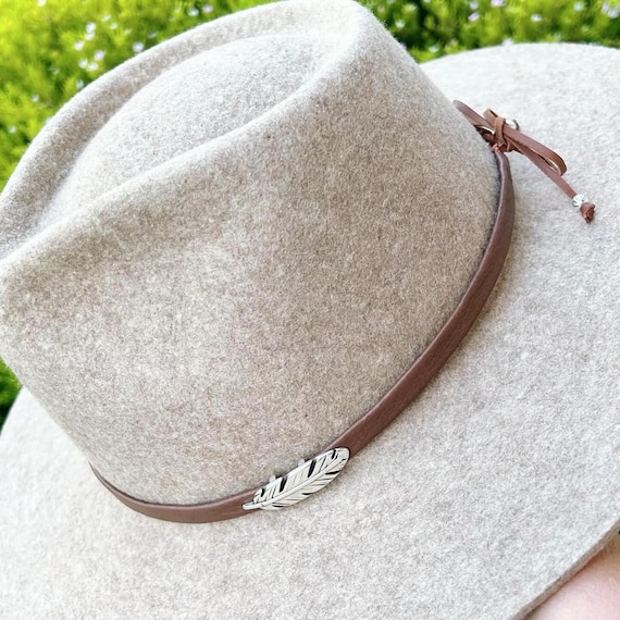 Leather hatbands with silver feather. Adjustable closure with sterling silver beads.