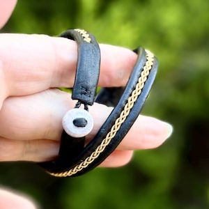 Traditional Sami inspired double wrap reindeer leather bracelet, with a braid of gold plated pewter threads. Unisex handmade to order.