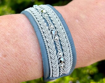 Sami inspired leather cuff, with traditional pewter braiding, chrystals and sterling silver beads. Handmade with a button or magnetic clasp.