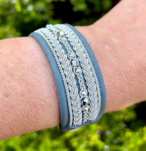 Sami inspired leather cuff, with traditional pewter braiding, chrystals and sterling silver beads. Handmade with a button or magnetic clasp.