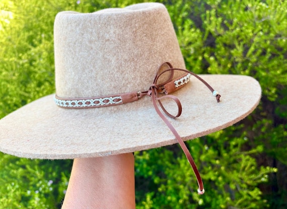 Sami inspired leather hatbands with pewter braiding and sterling silver threads.