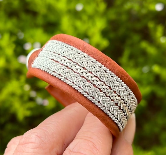 Traditional Nordic Sami inspired leather cuff, with pewter thread braids and pewter button. Unisex braided accessory.