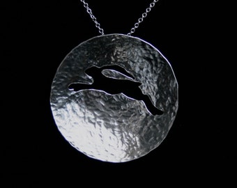 Traditionally handmade 'Leaping Hare' Pendant. A leaping hare sails across a concave full moon. Fully UK Hallmarked Sterling Silver