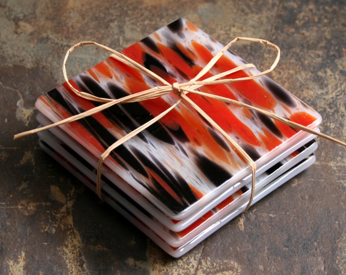 Fused glass coasters. 'Vampire Dreams - Opaline' A set of 4 sturdy coasters, made in stunning 'splashes' of reds and black on a white base.