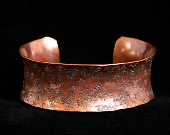 Medium anticlastic cuff bracelet 'Dandelion Wishes' Traditionally hand made with a hand stamped pattern. Torched flame finish copper.