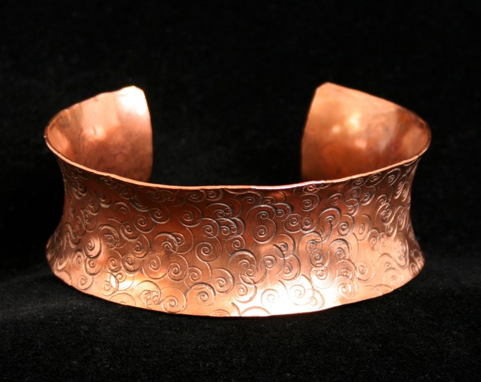 Medium anticlastic cuff bracelet 'Spirali' Traditionally hand made with a hand stamped pattern. Torched flame finish copper.